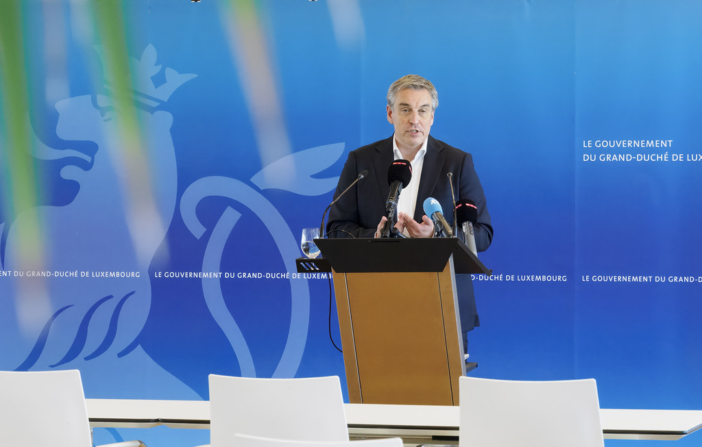Speaker at a press conference podium with microphones